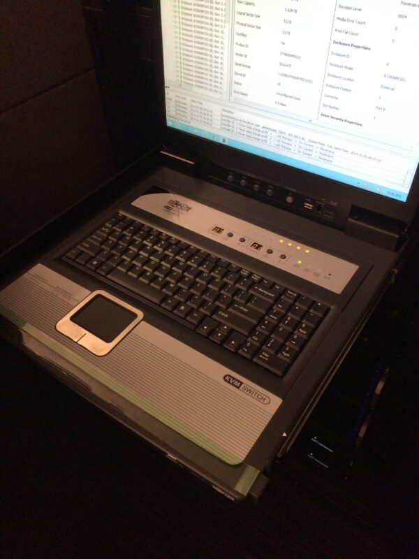 A laptop with a keyboard and mouse on top of it.