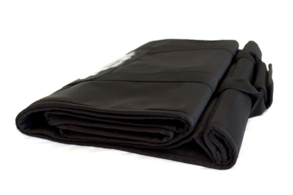 A black tarp is folded up on the floor.