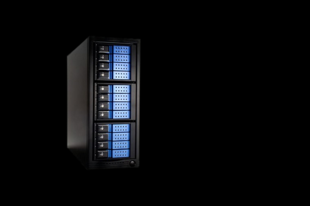 A black server rack with blue lights on it.